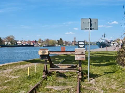 End of a track with a barrier and a river can be seen in the background Foto stock