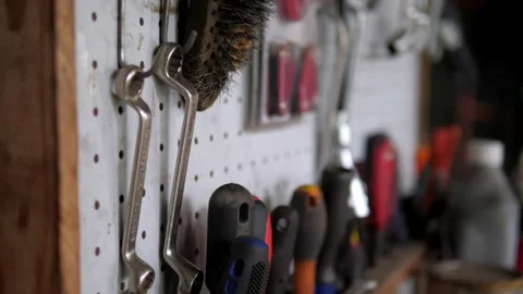 End wrenches hanging in on wall in old garage Stock Footage 195982028