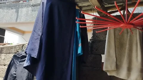 Endi is drying clothes Stock Footage 212263577