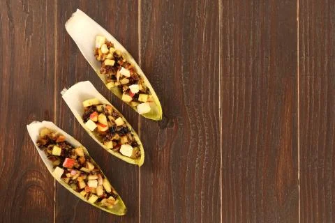 Endive or chicory salad with beetroot, goat cheese and nuts Stock Photos