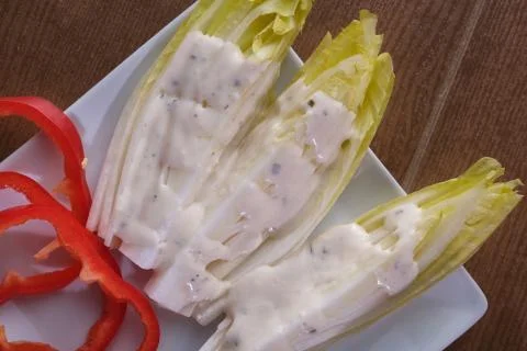 Endive salad with red pepper Stock Photos