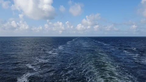 Endless blue sea waves with white foam after sailing vessel Stock Footage 115694926