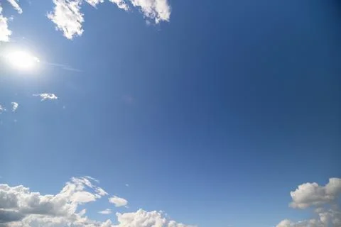 Endless blue sky adorned with fluffy white clouds during a bright afternoon Stock Photos