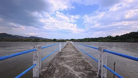 Endless bridge on a tropical island with low tide and jungle in Southeast Asia 動画素材 331190633