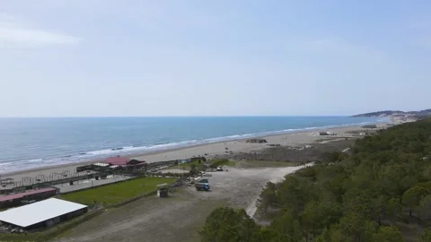 Endless deserted great beach of ulcinj, gray sand, trees, blue sky Off season Stock Footage 246774728