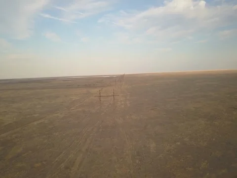 Endless Electricity lines in empty landscape Aerial pan. Stock Footage 80756520