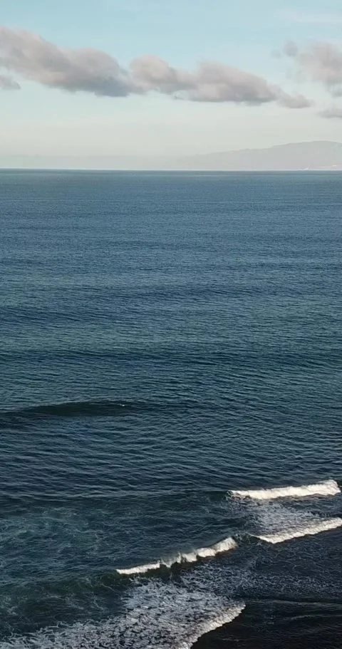 Endless expanse of deep blue ocean water with gentle waves rolling and Stock Footage 344786021