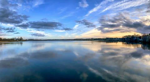 Endless expanses of the lake with reflections of the sky Stock Photos