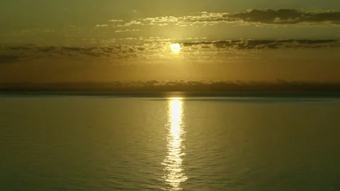The Endless Horizon Line in the Cloudy Ocean at Shiny Sunrise Stock Footage 308603696