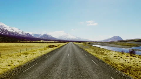 Endless Horizon of the Road Surrounded by Mountain Ranges Under a Blue Sky Video stock 157374324