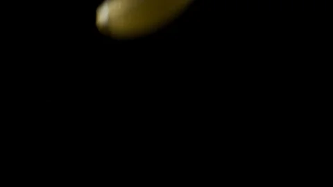 Endless lemon slices falling onto black surface Stock Footage 128720821