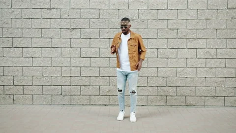 Endless loop of creative African American guy performing funny robot dance on Stock Footage 161399539