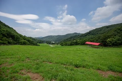 An endless range of mountains and a vast pasture ranch Stock Photos