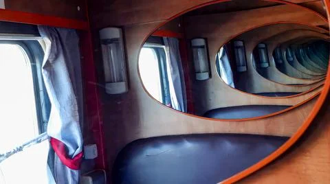 Endless reflections create mesmerizing optical illusion in train compartmen.. Stock Photos