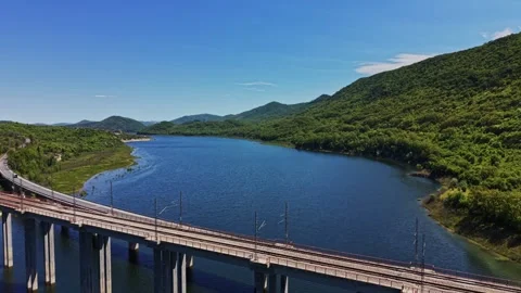 Endless river flows through green hills under blue sky Stock Footage 338276494