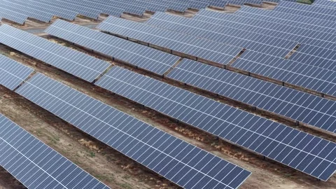 Endless rows of ground-mounted solar panels fill a large utility-scale solar Stock Footage 337670388