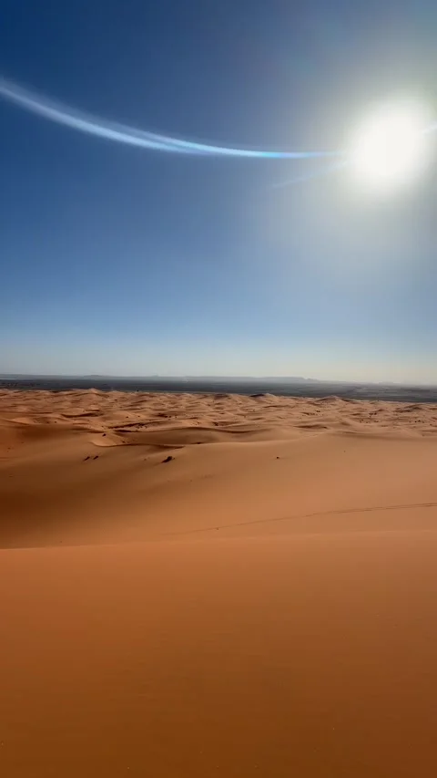 Endless Sahara Desert dunes under bright sun Morocco Stock Footage 334695189