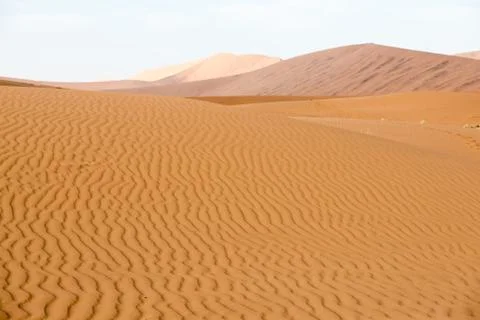 Endless sand waves on a sand dune of Namib Desert Stock Photos
