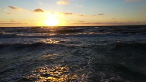 Endless sea with large waves against sky with clouds and sun Stock Footage 148782588