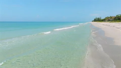 Endless shoreline with crystal clear waves hitting sand in Nokomis. Stunning Stock Footage 247702467