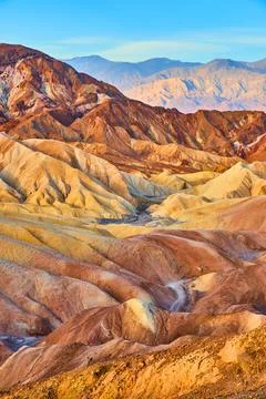 Endless waves of color in eroded sediment at Death Valley Stock Photos