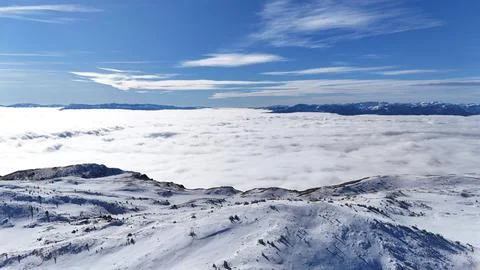 Endless White Clouds Covering Mountain Valley in Winter Stock Photos