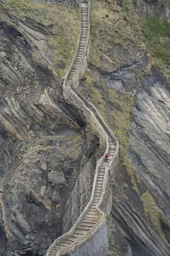 Endless zigzagging stone steps on a rocky mountain slope by the sea. Photos