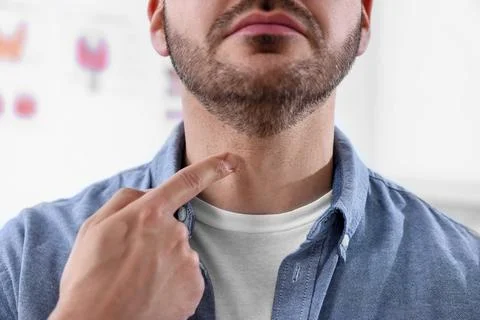 Endocrine system. Man doing thyroid self examination indoors, closeup Stock Photos