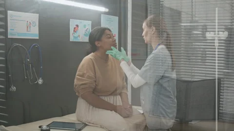 Endocrinologist Palpating Lymph Nodes of Womans Neck during Medical Examination Stock Footage 333683741