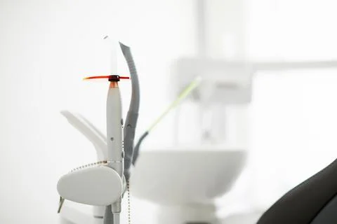Endodontic instruments on white. Dental polymerization UV lamp. UV tool. Stock Photos