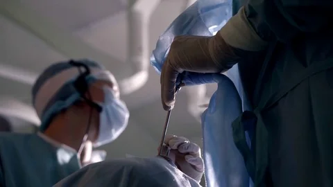 Endoscopic operation through nasal hole, hands of surgeon and face of his Stock-Footage 83323049
