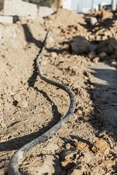 The ends of the electrical cable in the trench. Electrical cable installation Stock Photos