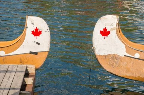 Ends of two canoes with copyspace and canadian red maple leaf (digitally incl Stock Photos