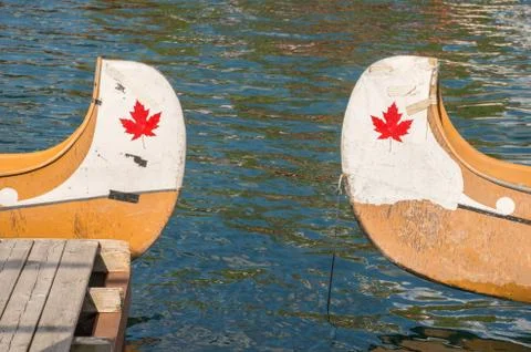 Ends of two canoes with copyspace and canadian red maple leaf Stock Photos