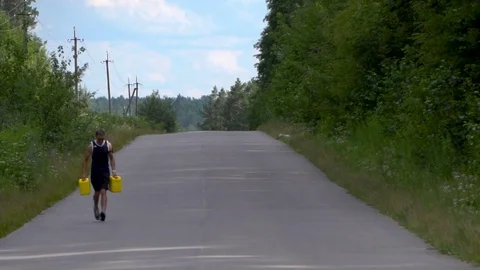 Endurance test and purposefulness with jerrycans in hands Video stock 80436935