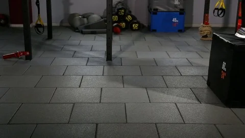 Enduring man jumps on the wooden cube in the gym Stock Footage 75348038