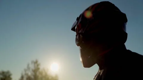 Enduro motorcyclist looking at the sun Video stock 233186331