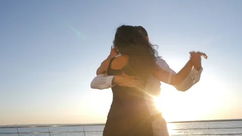 Energetic attractive young spanish couple dancing latin Bachata near sea or Stock Footage