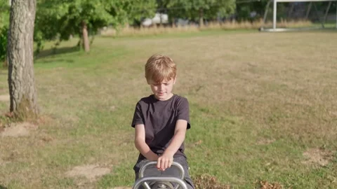 An Energetic Boy is Screaming on a Seesaw 库存影片 346642047