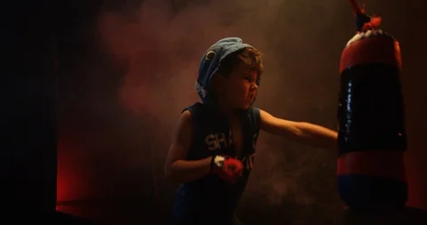 Energetic boy training boxing on punching bag at the gym Video stock 112075471