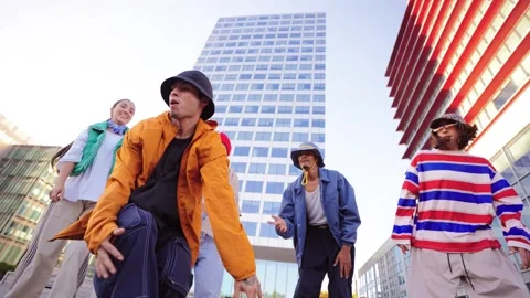 Energetic Breakdancer Showcasing a Skillful Freeze Move while Friends Support Stock Footage 306300465
