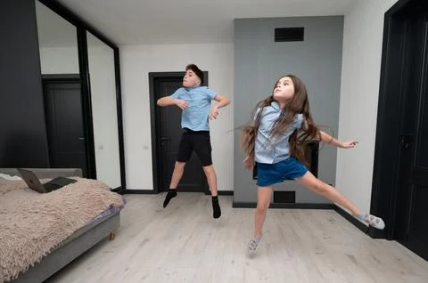 Energetic children express joy through dance in a modern living room during an Stock Photos