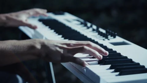 Energetic Close-Up of Hands Playing Electronic Keyboard in Bright Spotlight Stock Footage 284482746