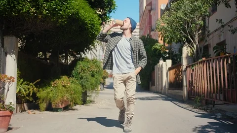 Energetic cool man dancing on way home and rejoicing listening fun music with Stock Footage 108436804