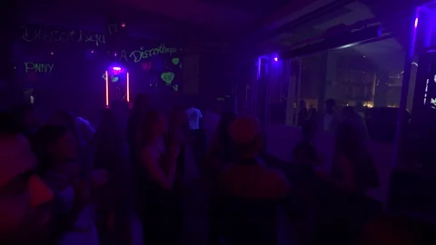 Energetic Crowd Dancing Under Purple Lights at Damaria Bali Discotheque 4K Video stock 335140537