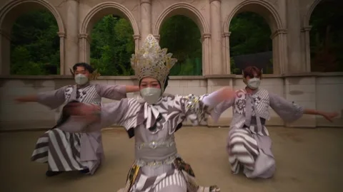 Energetic Cultural Dance Performance by Masked Trio in Stone Theater Stock Footage 276349062