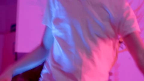 An Energetic Dance Move Performed Under Vibrant Neon Lights Stock Footage 316490520