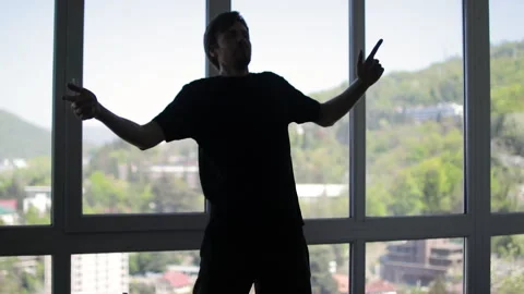 Energetic dancer is performing various moves, enjoying music and expressing Stock Footage 306948747