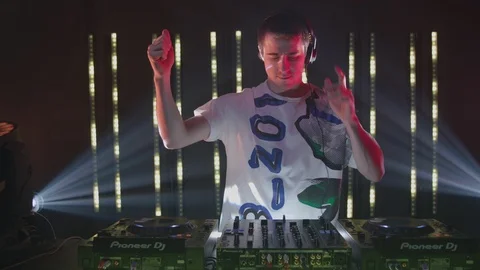 Energetic dj dancing and mixing music at the nightclub Stock Footage 87151453