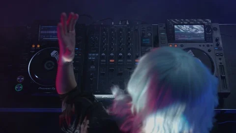 Energetic dj dancing while playing music at the nightclub Stock Footage 87562306